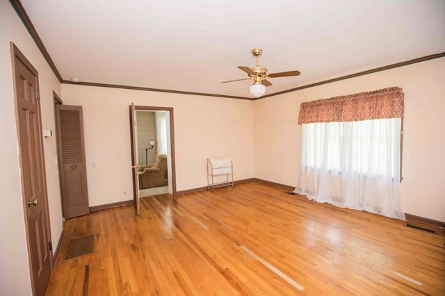 interior space with crown molding, ceiling fan, and light wood-type flooring