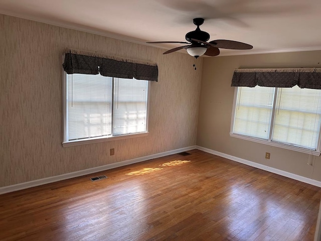 empty room featuring crown molding, ceiling fan, and hardwood / wood-style flooring