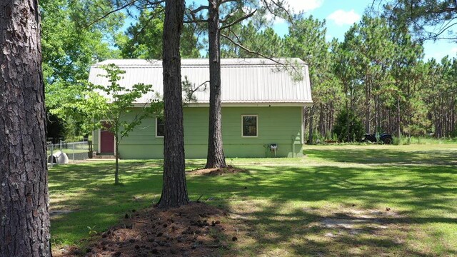 6715 Stewart Rd, Ochlocknee, GA 31773 - view of side of property with a lawn and metal roof
