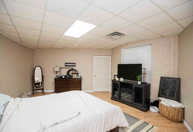 6715 Stewart Rd, Ochlocknee, GA 31773 - bedroom with light wood-style flooring, baseboards, and a paneled ceiling