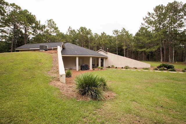 6715 Stewart Rd, Ochlocknee, GA 31773 - view of side of property featuring a lawn, stucco siding, and cooling unit