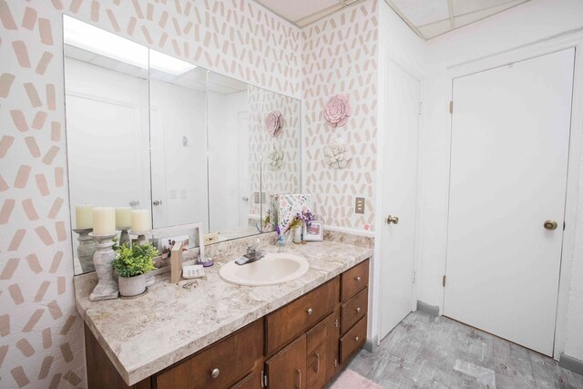 6715 Stewart Rd, Ochlocknee, GA 31773 - bathroom featuring wallpapered walls, wood finished floors, and vanity