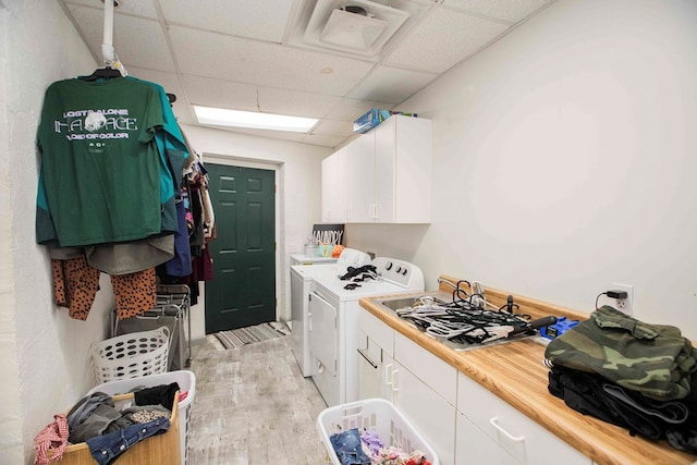 6715 Stewart Rd, Ochlocknee, GA 31773 - washroom with light wood-type flooring, cabinet space, and washer and dryer