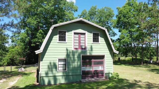 6715 Stewart Rd, Ochlocknee, GA 31773 - rear view of property with a detached garage, a gambrel roof, and an outbuilding
