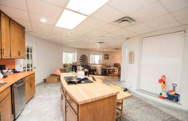 6715 Stewart Rd, Ochlocknee, GA 31773 - kitchen with butcher block counters, dishwasher, a kitchen island, a paneled ceiling, and electric cooktop