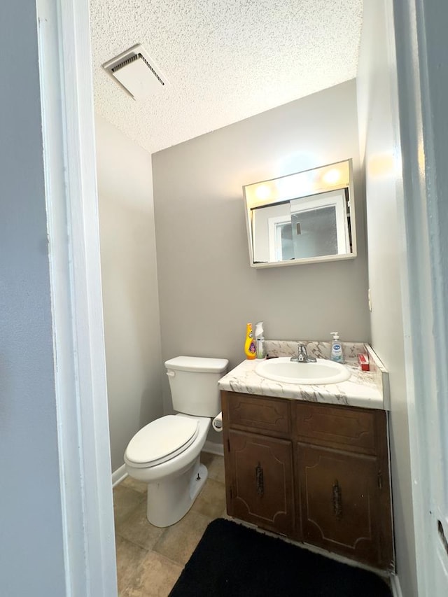 1197 Jo Ree St, Valdosta, GA 31601 - half bathroom featuring vanity, a textured ceiling, and tile patterned flooring