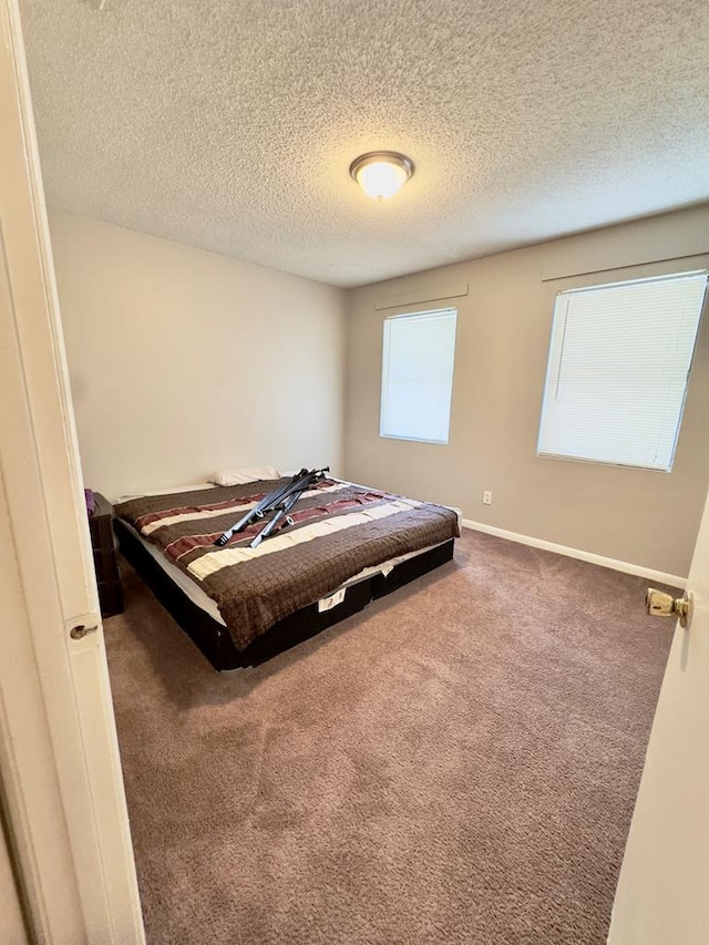 1197 Jo Ree St, Valdosta, GA 31601 - carpeted bedroom with a textured ceiling and baseboards