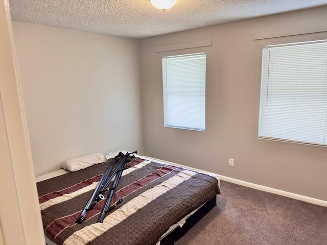 1197 Jo Ree St, Valdosta, GA 31601 - carpeted bedroom featuring a textured ceiling and baseboards