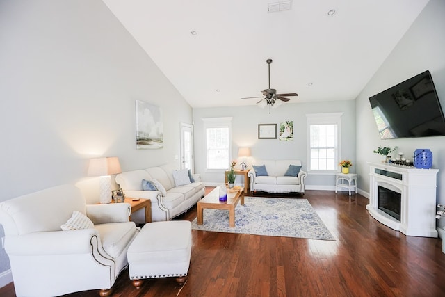351 Virginia Cir, Cairo, GA 39828 - living area with dark wood-style flooring, baseboards, ceiling fan, high vaulted ceiling, and a fireplace