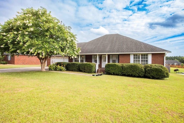 ranch-style home featuring a garage and a front yard