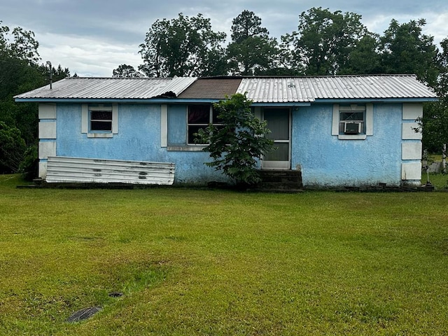 1038 Church St, Barwick, GA 31720 - back of house featuring stucco siding, entry steps, a yard, and metal roof