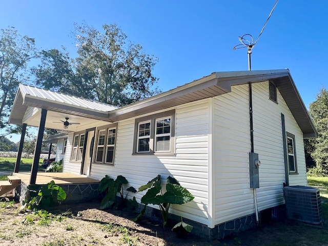 view of side of property with ceiling fan, central air condition unit, and a porch