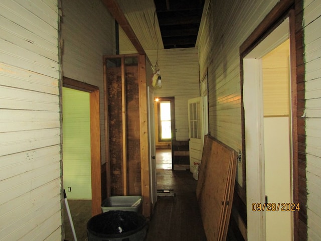 corridor featuring wood walls