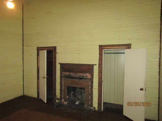 unfurnished living room with a brick fireplace