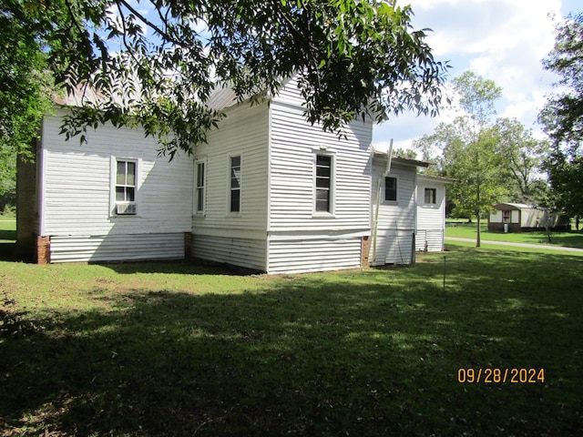 view of side of property with a yard