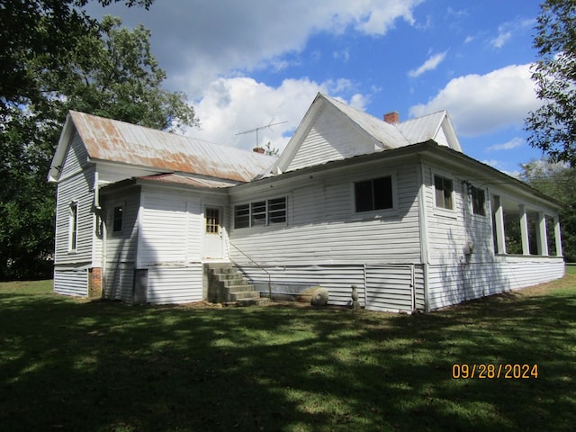 view of home's exterior with a lawn