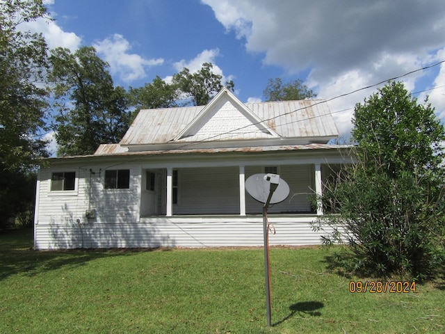 view of side of home with a yard