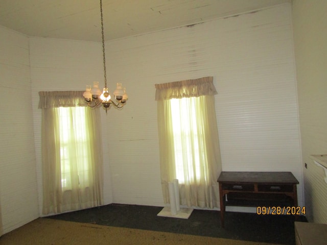 spare room featuring a chandelier