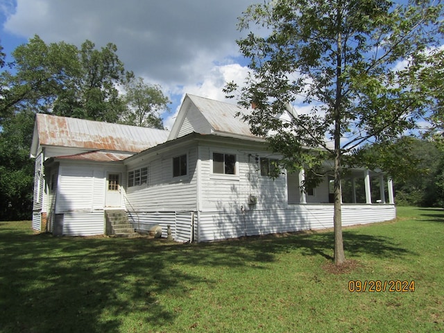 view of side of home featuring a lawn