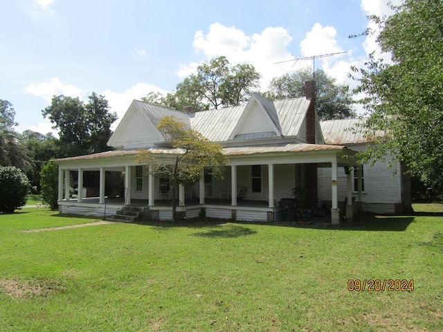 back of property featuring a yard and a porch