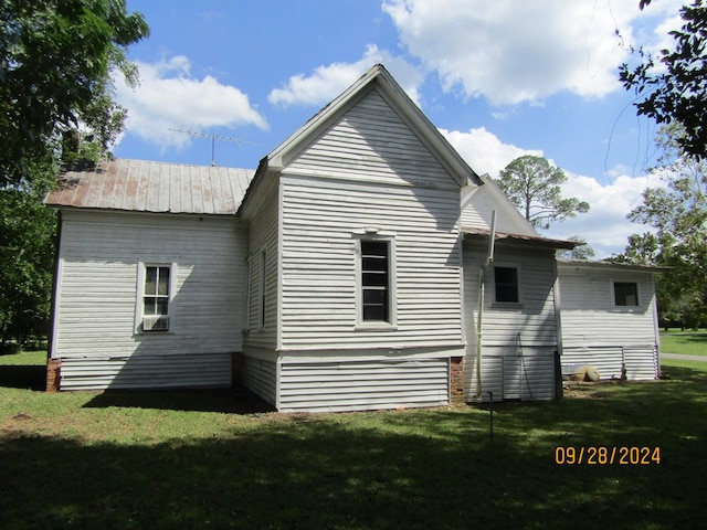 rear view of property featuring a yard