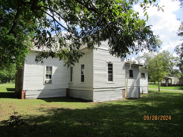 view of property exterior with a yard