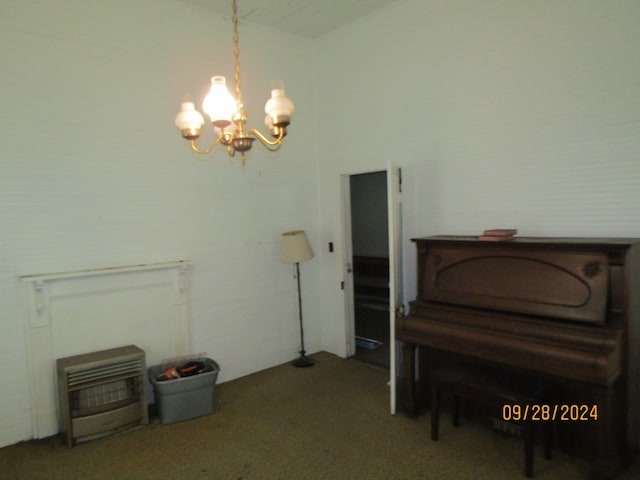 misc room featuring carpet flooring and a notable chandelier