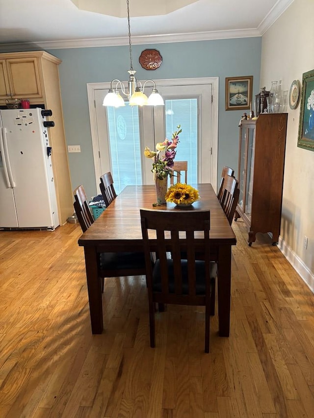 3794 Pine Park Rd, Cairo, GA 31778 - dining area featuring crown molding, an inviting chandelier, baseboards, and light wood-style floors