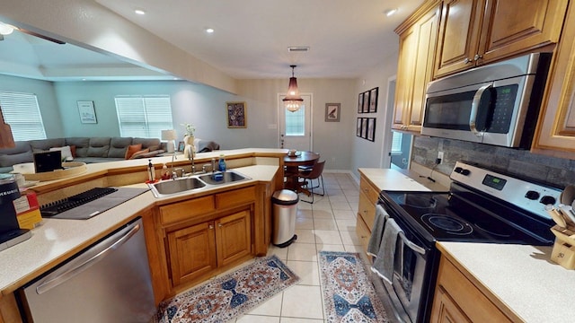 106 Hayden Way, Thomasville, GA 31792 - kitchen with stainless steel appliances, a sink, open floor plan, light countertops, and light tile patterned floors