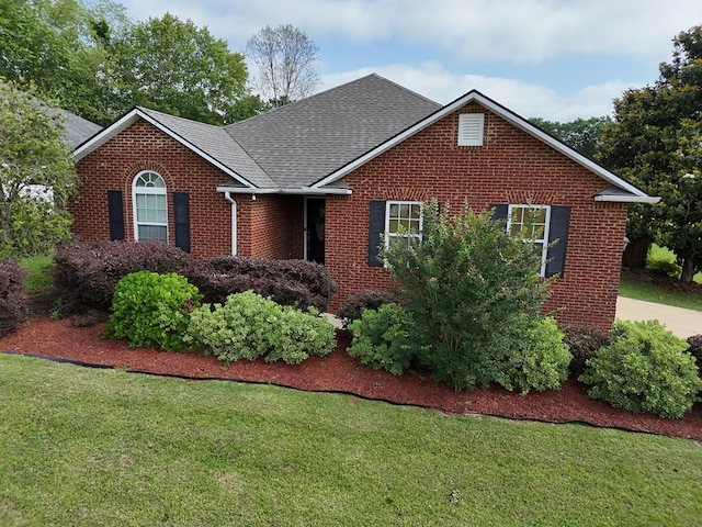 106 Hayden Way, Thomasville, GA 31792 - view of front of home featuring brick siding, a front lawn, and roof with shingles