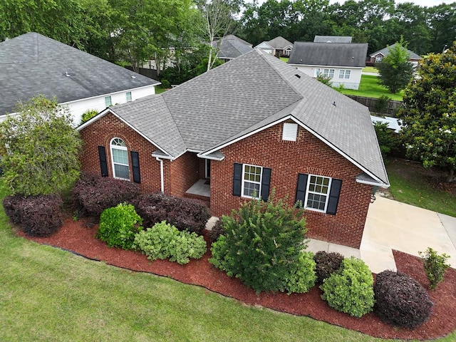 106 Hayden Way, Thomasville, GA 31792 - traditional-style house featuring brick siding, a shingled roof, and a front lawn
