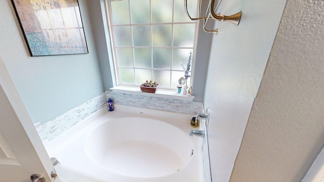 106 Hayden Way, Thomasville, GA 31792 - bathroom with a textured wall and a bath