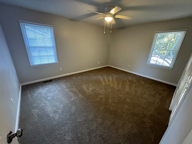 carpeted spare room with ceiling fan