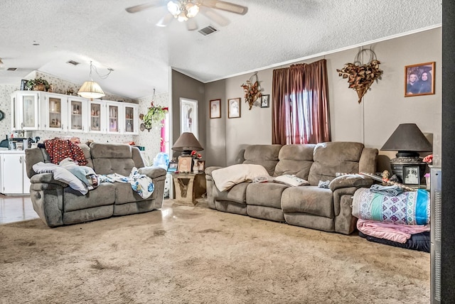 living room featuring ceiling fan, ornamental molding, lofted ceiling, and a textured ceiling