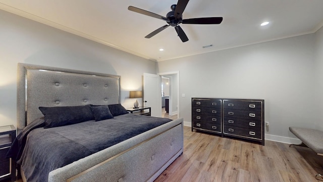 bedroom with light hardwood / wood-style flooring, ceiling fan, and ornamental molding