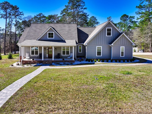 view of front of home featuring covered porch and a front yard