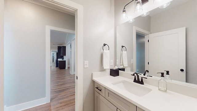 bathroom featuring hardwood / wood-style flooring and vanity