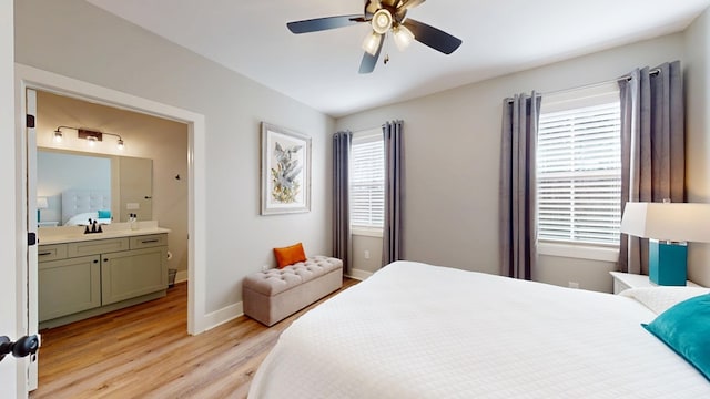 bedroom with sink, ceiling fan, light hardwood / wood-style floors, and ensuite bathroom