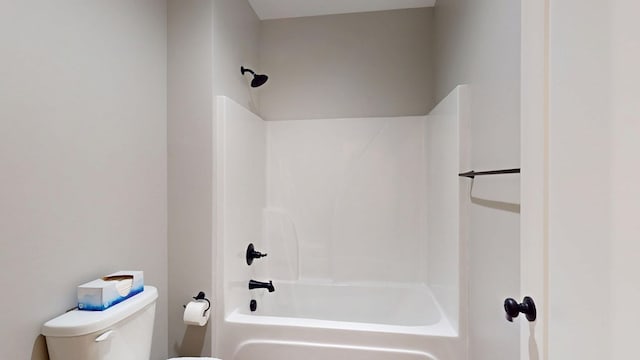 bathroom featuring shower / bath combination and toilet