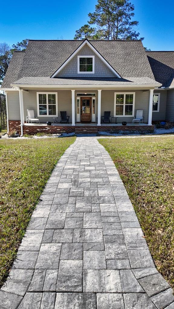 view of front of home featuring a front lawn and a porch