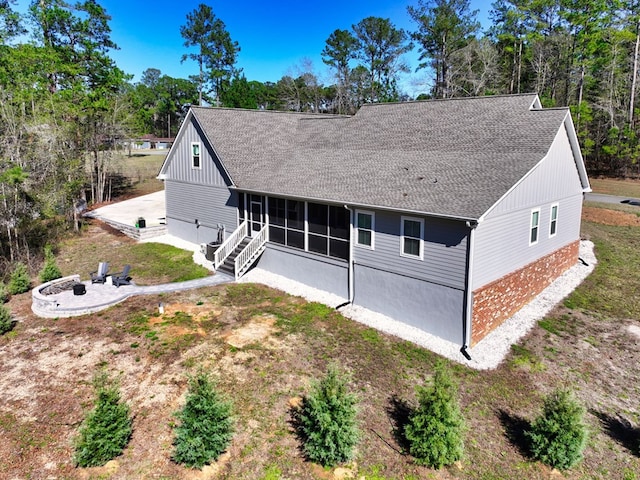 back of property featuring a yard and a sunroom