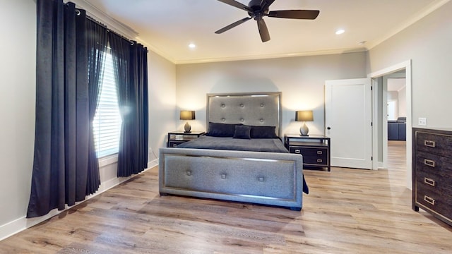 bedroom featuring light hardwood / wood-style floors, crown molding, and multiple windows