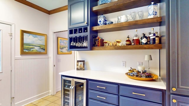 bar featuring a bar, light tile patterned floors, beverage cooler, and crown molding