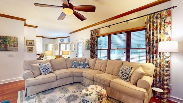 living room with baseboards, wood finished floors, a ceiling fan, and crown molding