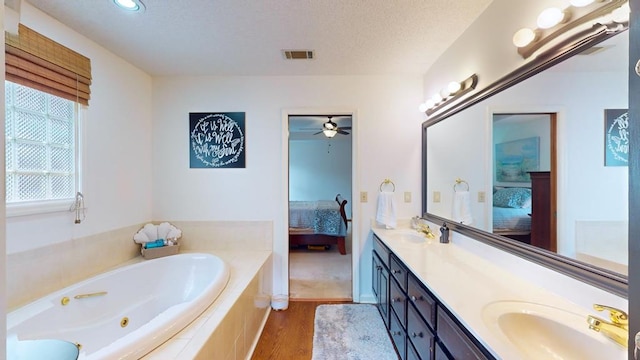 full bathroom featuring visible vents, connected bathroom, a sink, and double vanity