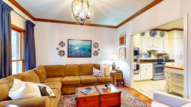 living room with crown molding, light wood-style flooring, and an inviting chandelier