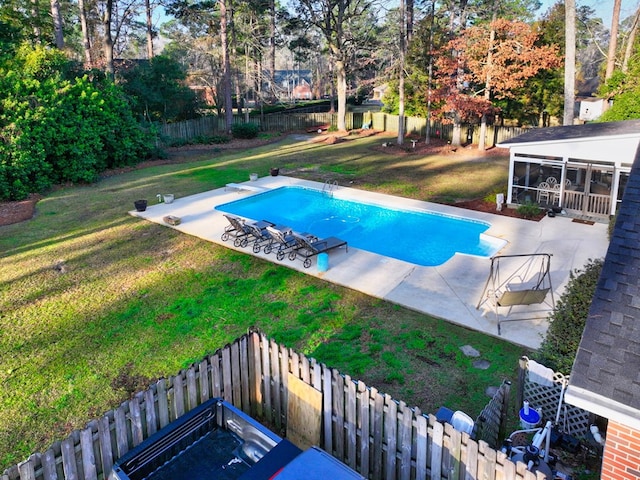 view of pool with a sunroom, a fenced backyard, a patio, and a yard