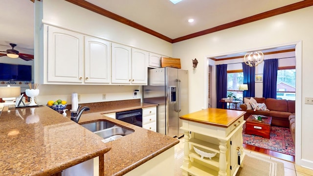 kitchen with black dishwasher, a sink, stainless steel fridge, and dark stone countertops