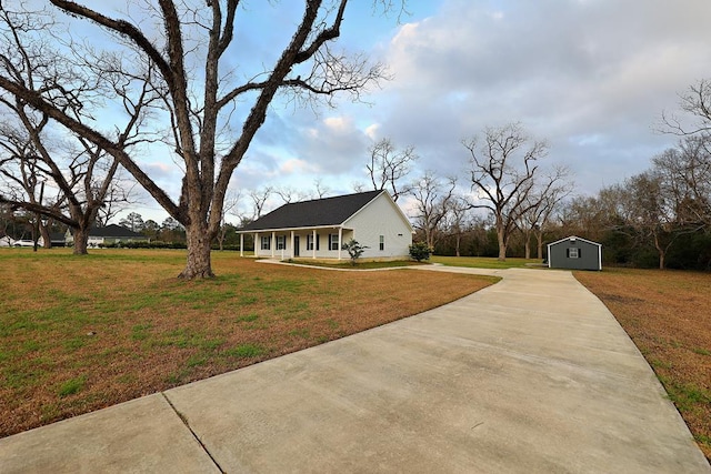 view of front facade with a shed and a front lawn