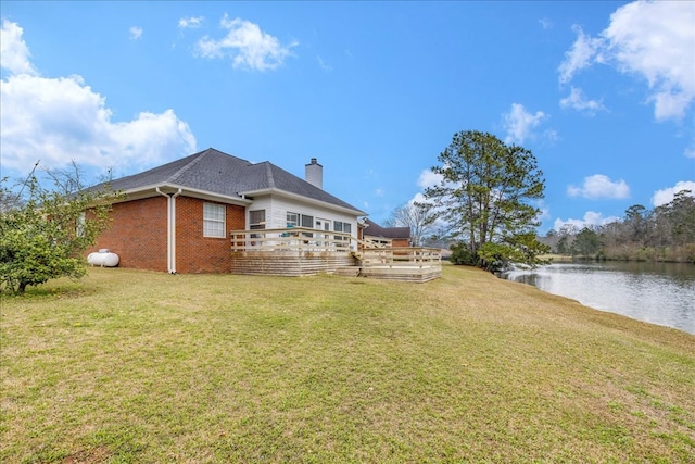 view of yard with a deck with water view